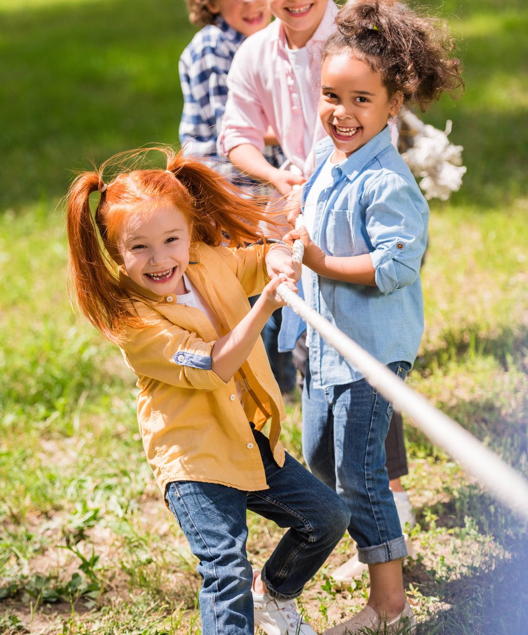 Children playing tug-of-war outdoors